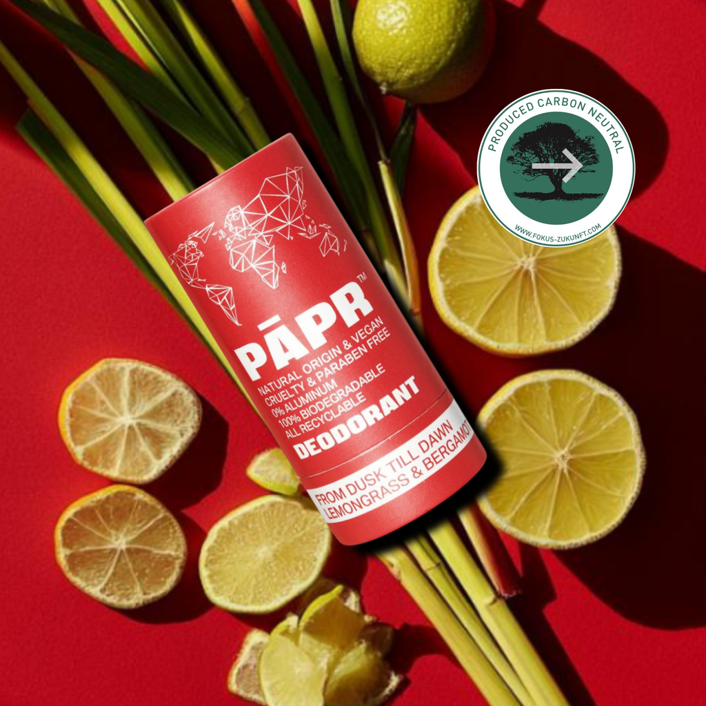 Red deodorant tube labeled 'PAPR' with citrus and grass on a red background