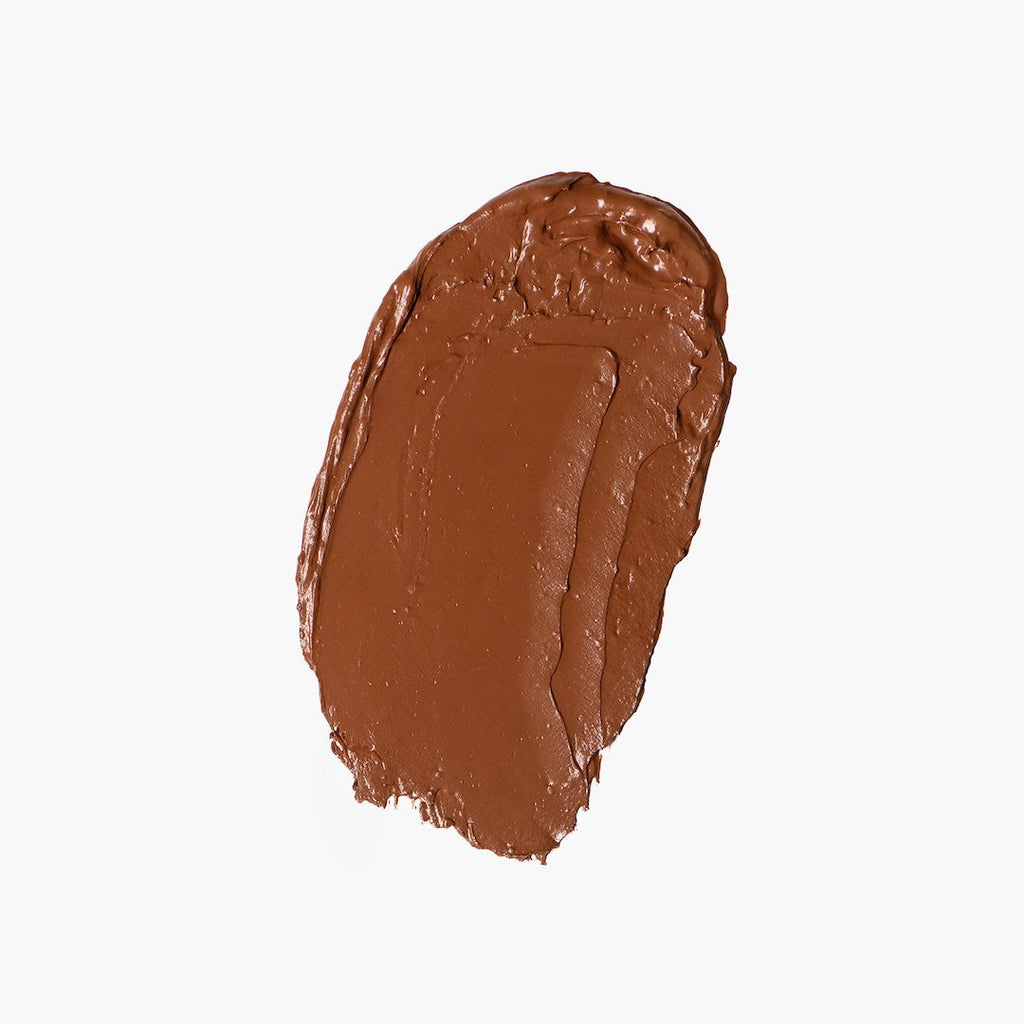 Brown foundation swatch on a white background