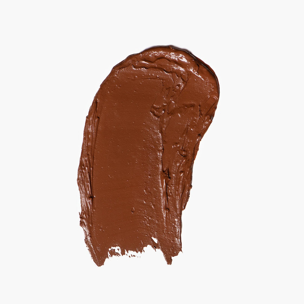 Brown foundation swatch on a white background