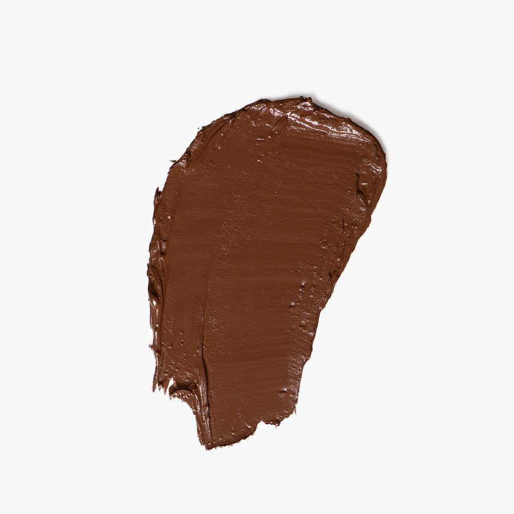 Brown foundation swatch on a white background