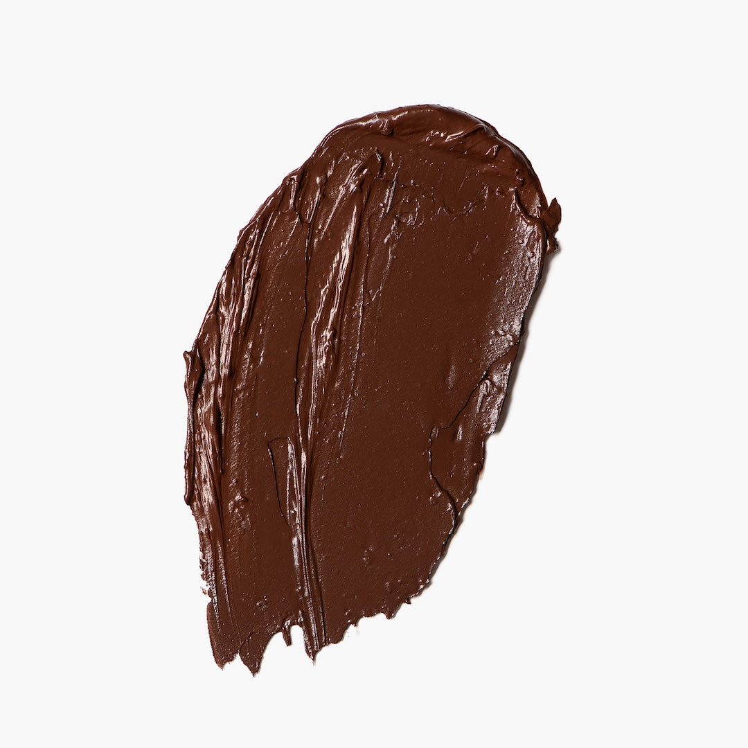 Brown foundation swatch on a white background