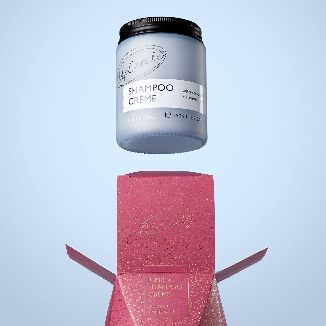 Shampoo crème container with packaging on a light blue background