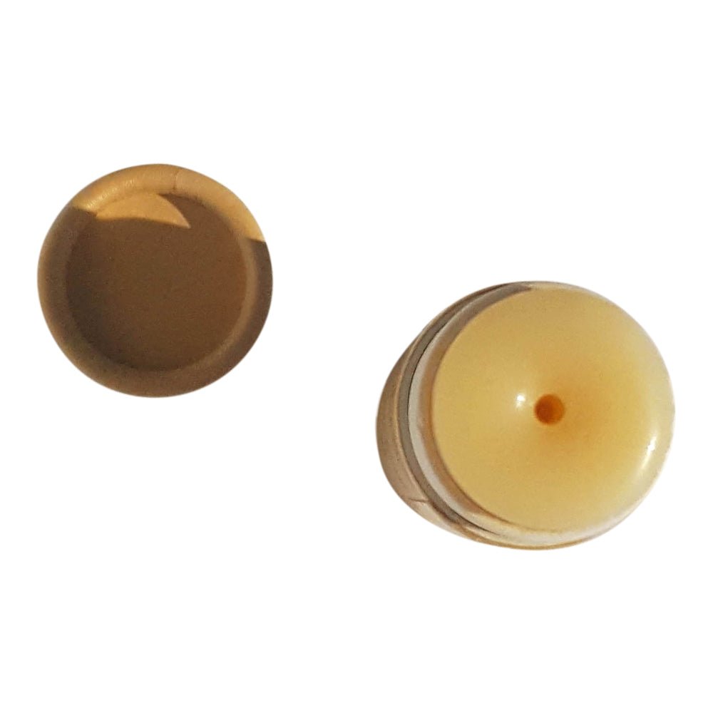 Lip Balm and paper cap seen from above on a white background