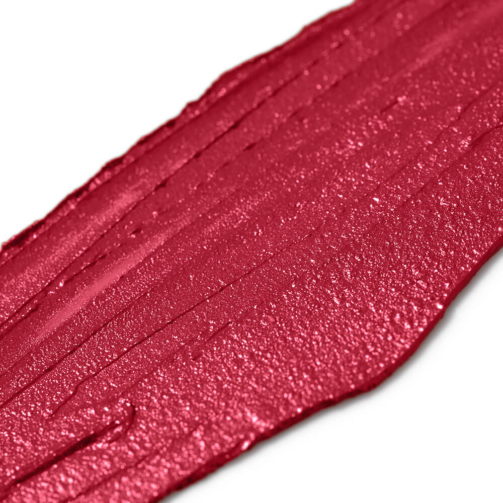 Close-up of a swatch of red lipstick with a glossy finish on a white background