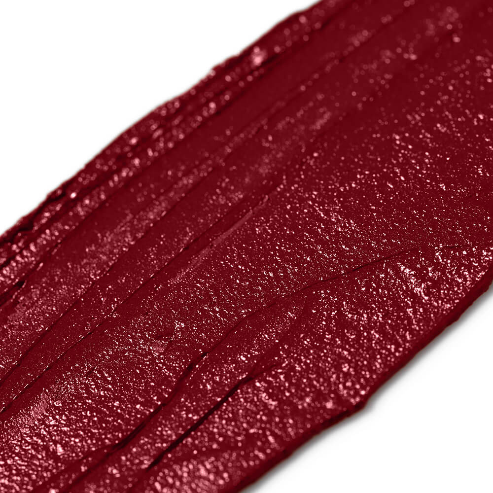 Close-up of a swatch of red lipstick on a white background