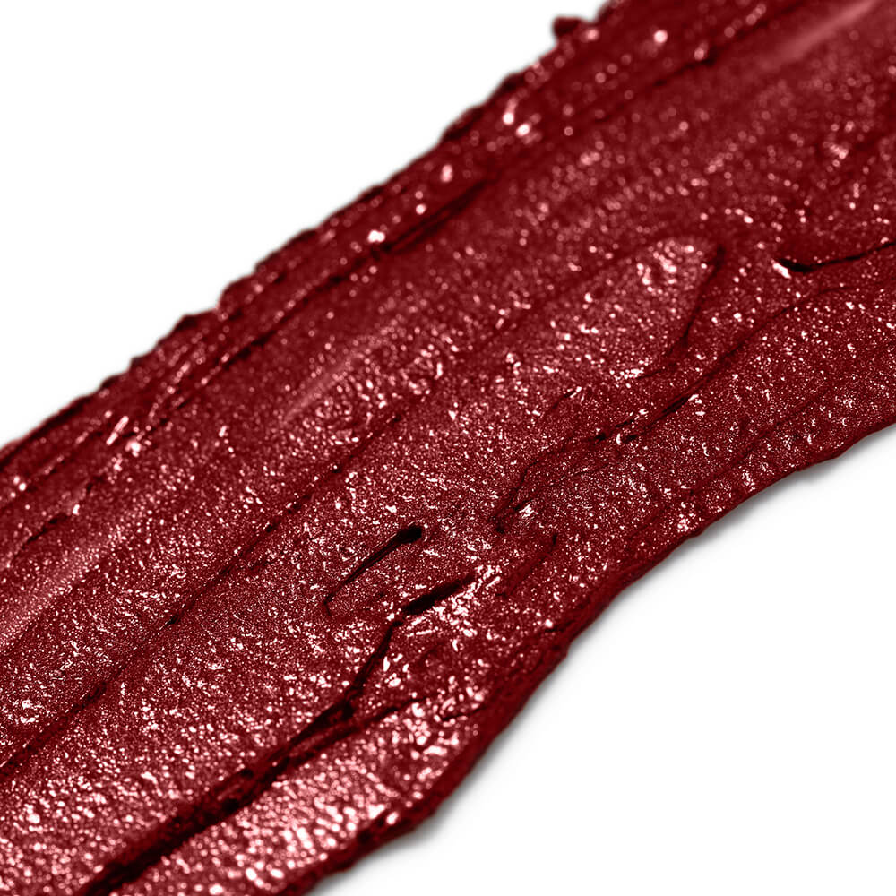 Close-up of a swatch of red lipstick with a glossy finish on a white background