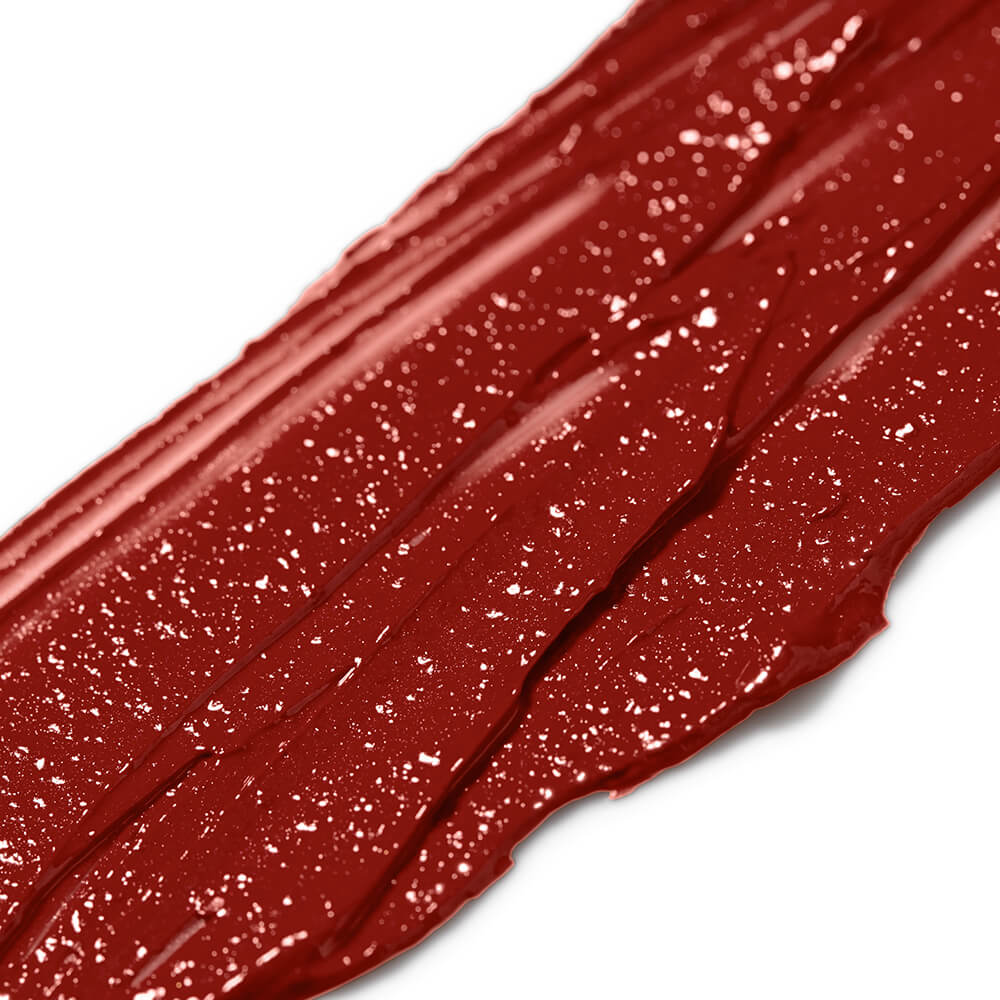 Close-up of red makeup swatch on a white background