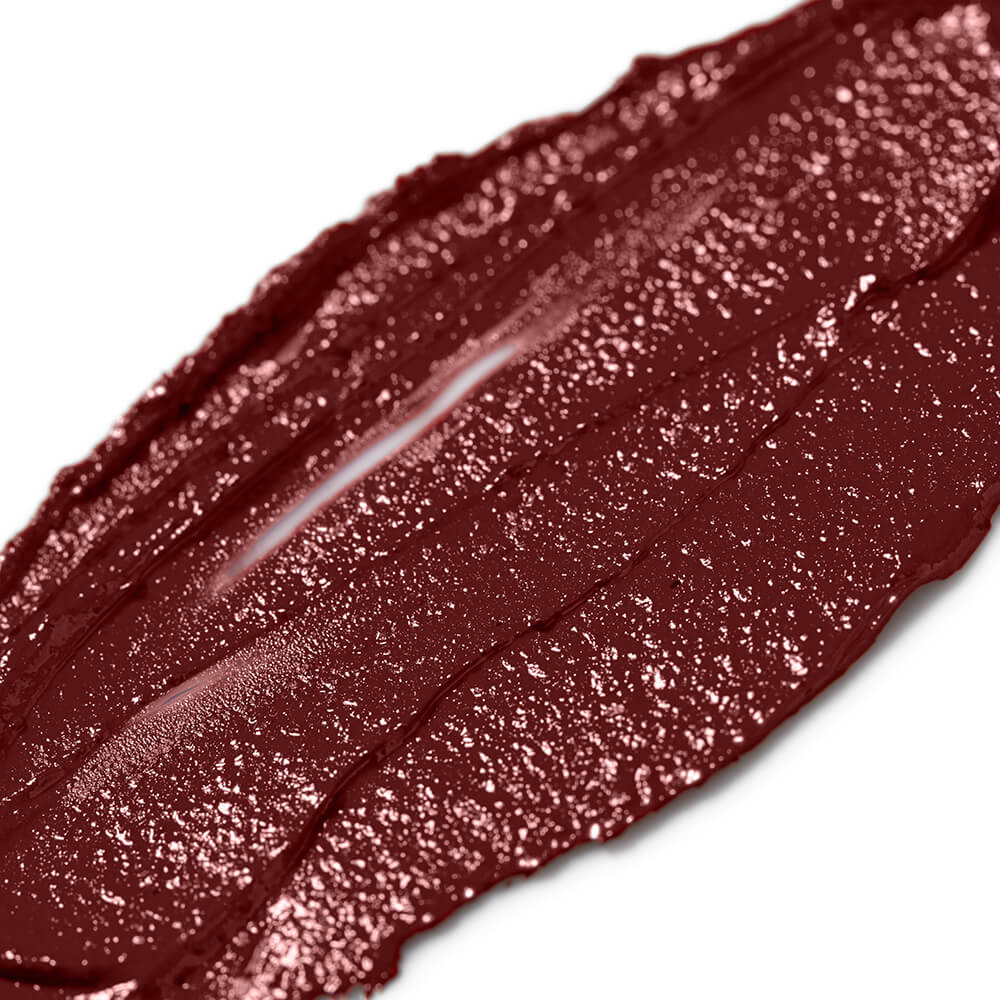 Close-up of a smudge of dark red lipstick on a white background