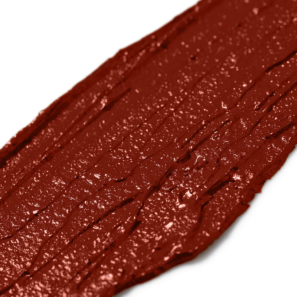 Close-up of a orange red makeup swatch on a white background