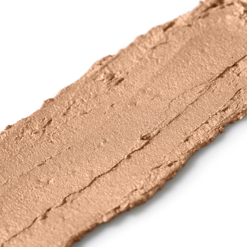 Close-up of a swatch of brown makeup powder on a white background