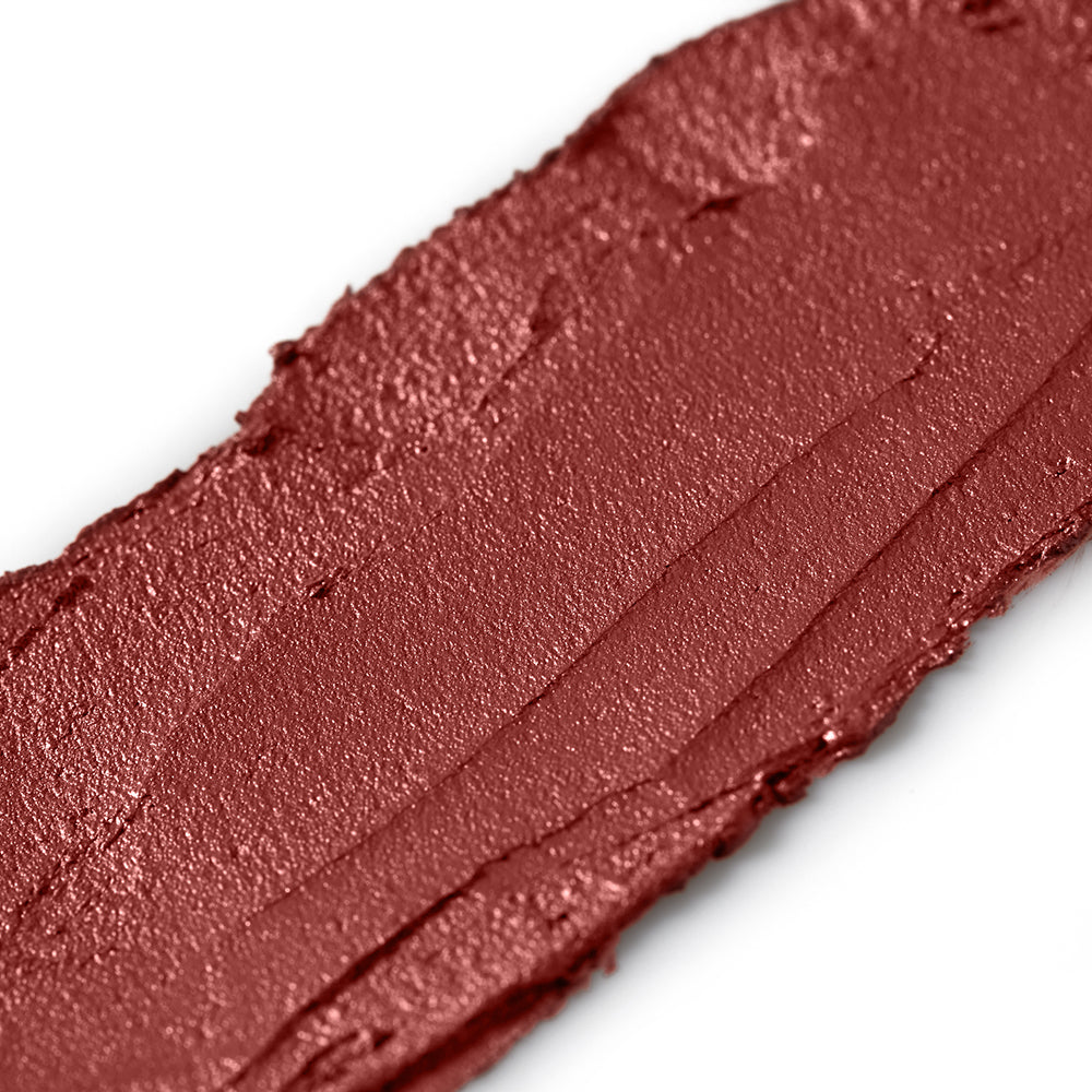 Close-up of a swatch of plum makeup on a white background