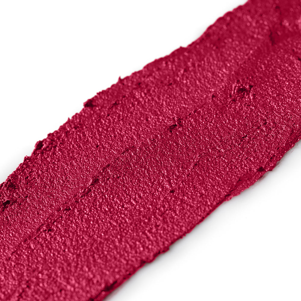 Close-up of a swatch of fuchsia lipstick on a white background