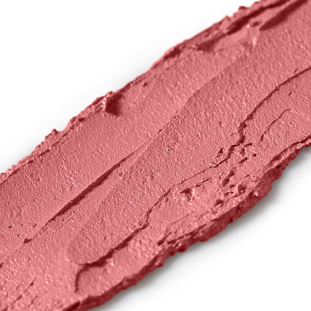 Close-up of a swatch of pink makeup on a white background