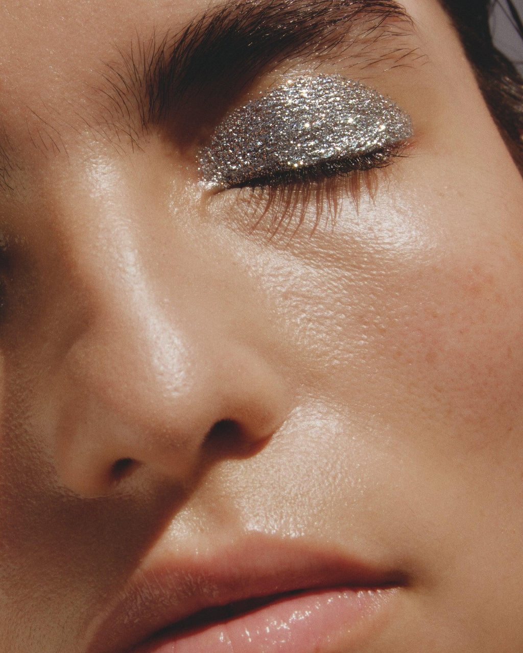 Close-up of a person's eye with silver glittery eye makeup