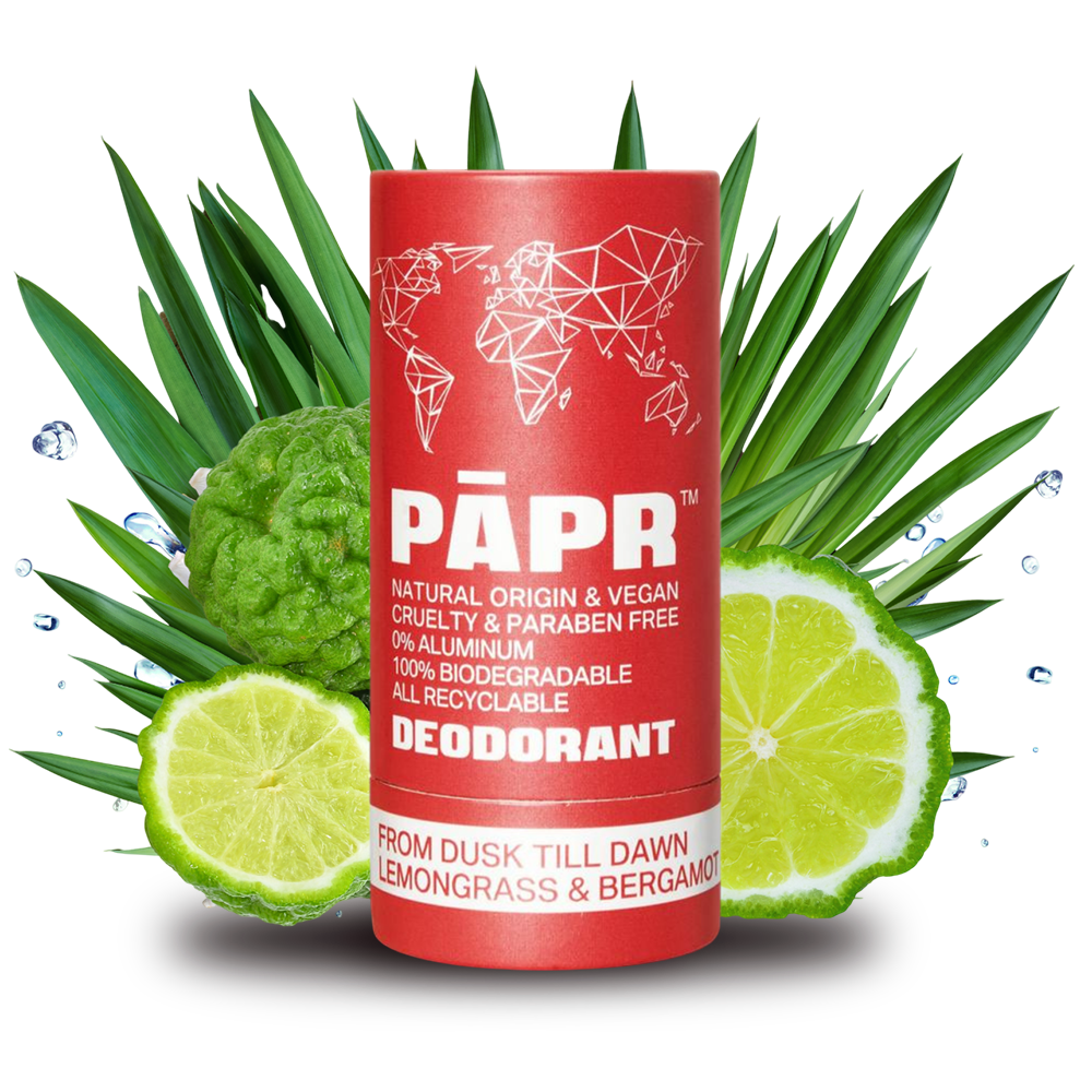Red deodorant tube with green leaves and citrus fruit on a transparent background