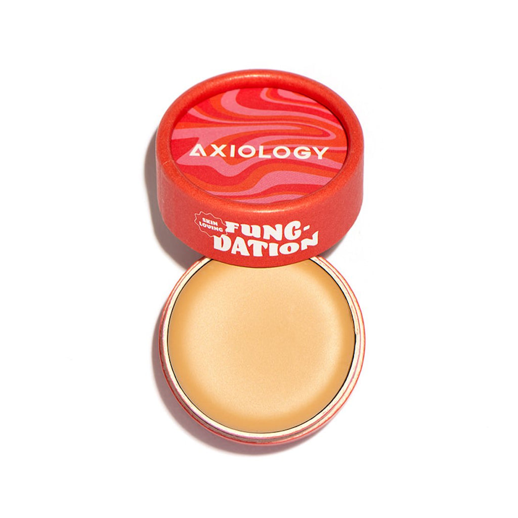 Axiology foundation product with red lid on a white background