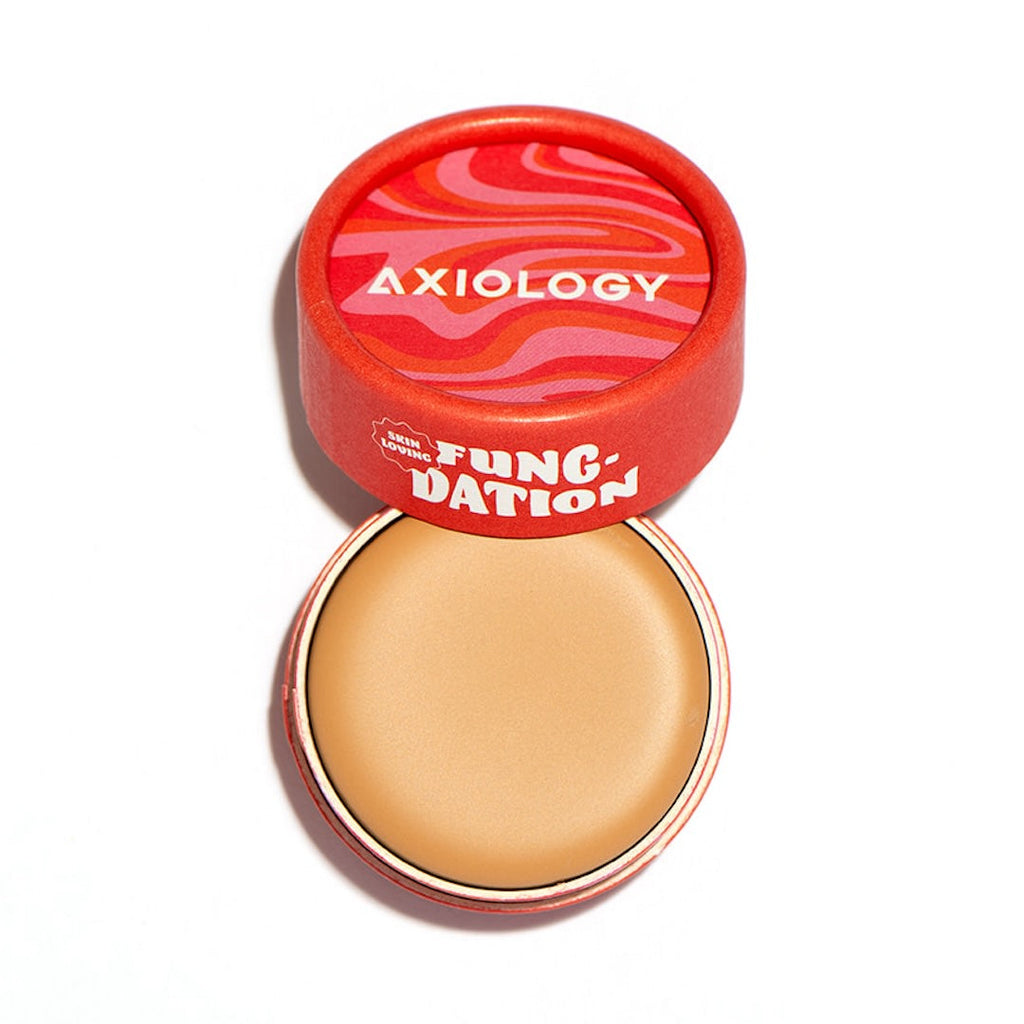 Axiology foundation pot with red lid on a white background