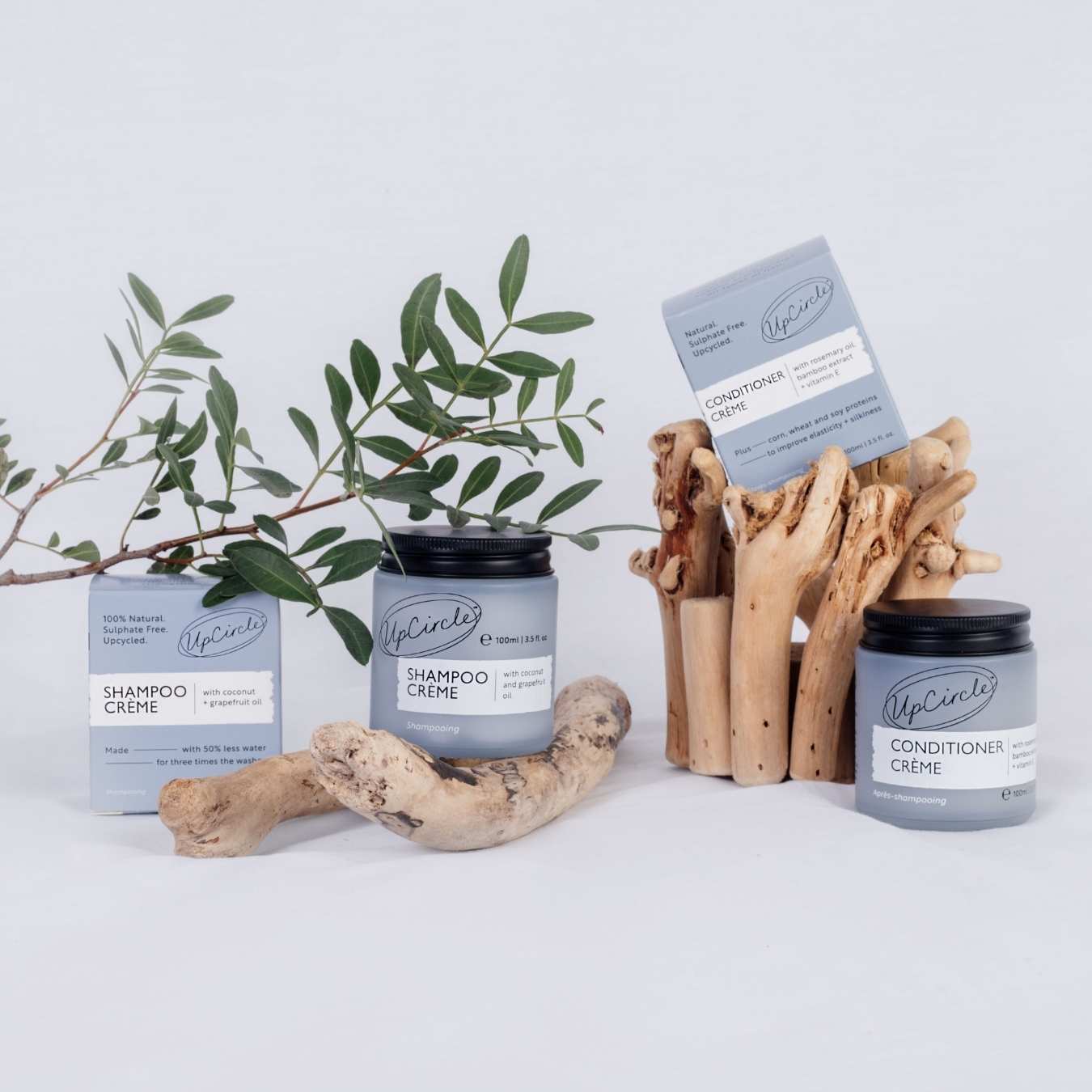 UpCircle shampoo and conditioner cream jars with packaging on a white background