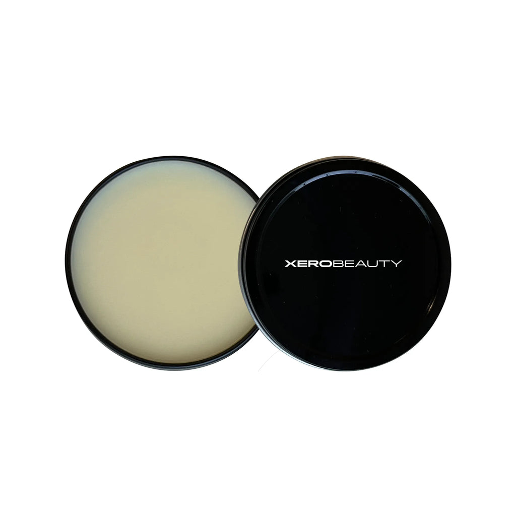 Cosmetic container with cream inside and black lid featuring 'Xerobeauty' on a white background