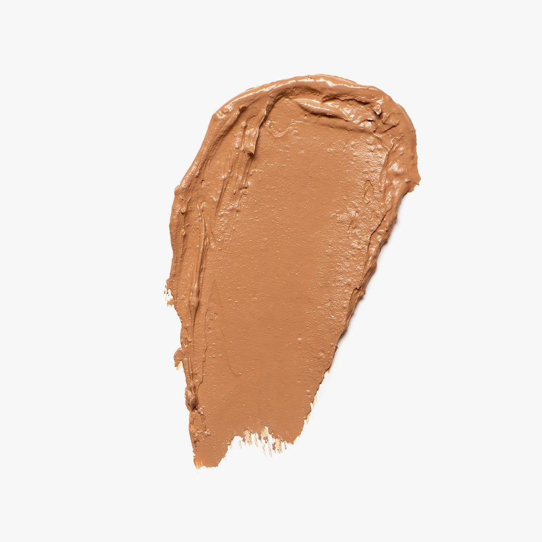 Swatch of light brown foundation on a light gray background
