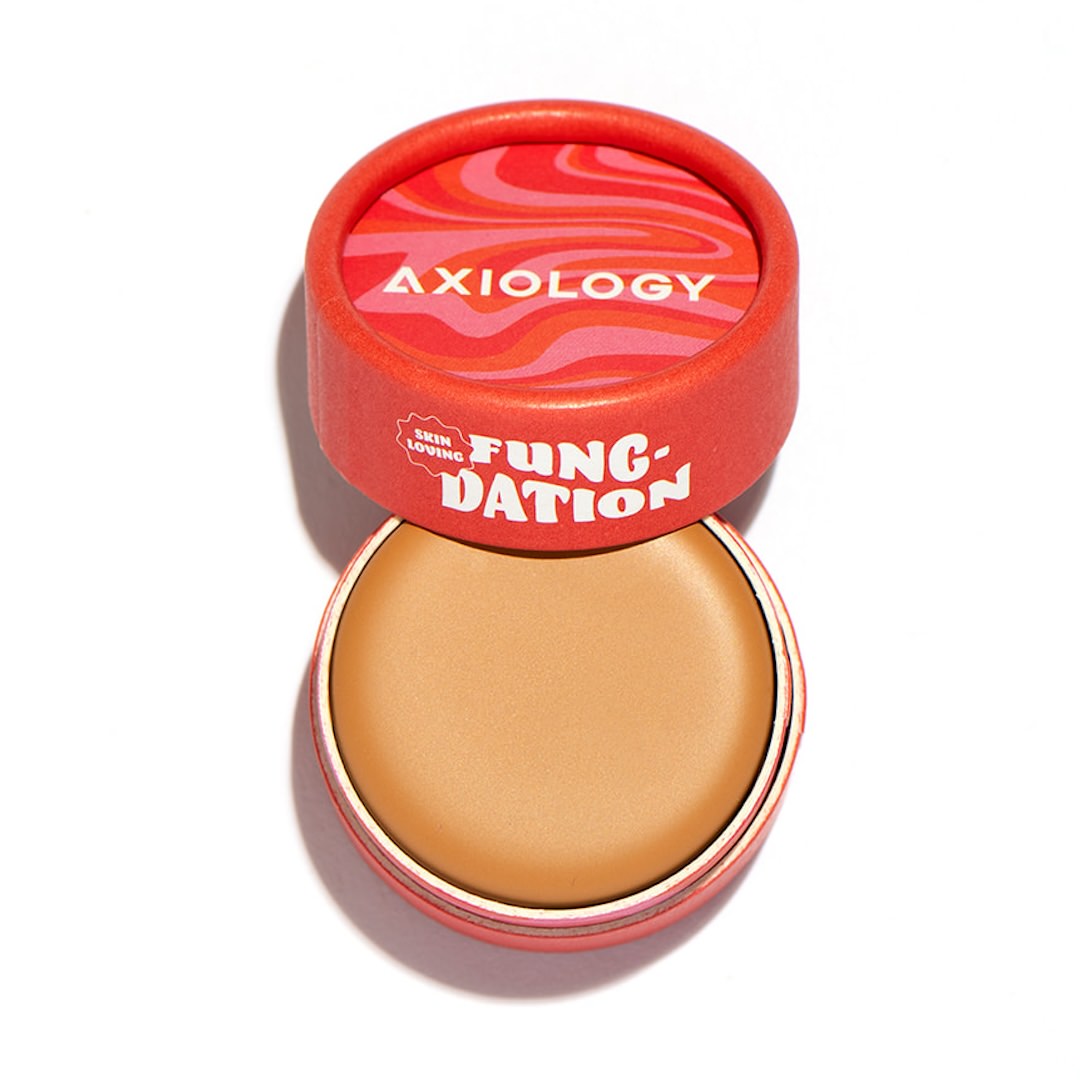Foundation pot with red lid featuring 'Axiology' branding on a white background