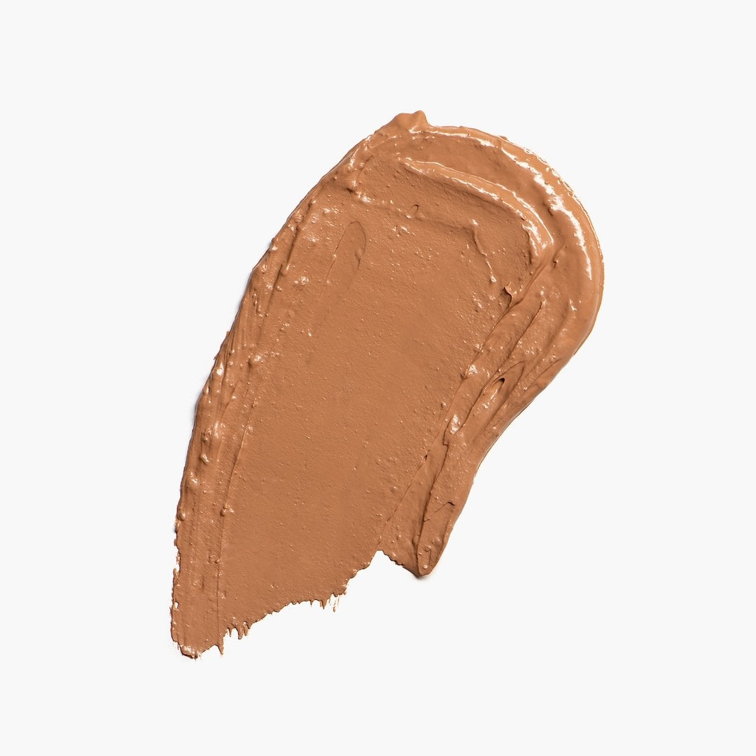 Light brown foundation swatch on a white background