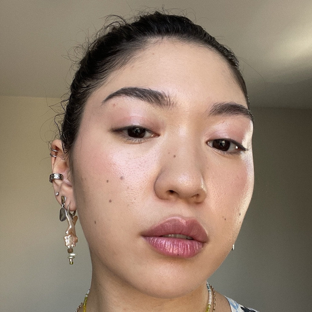 Close-up of a person with earrings and a blurred background