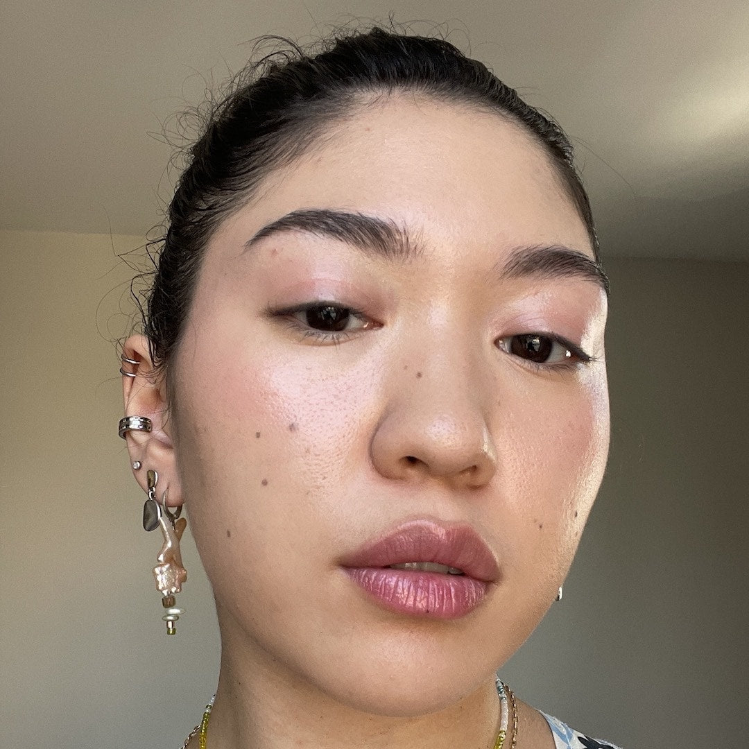 Close-up of a person with earrings and a blurred background