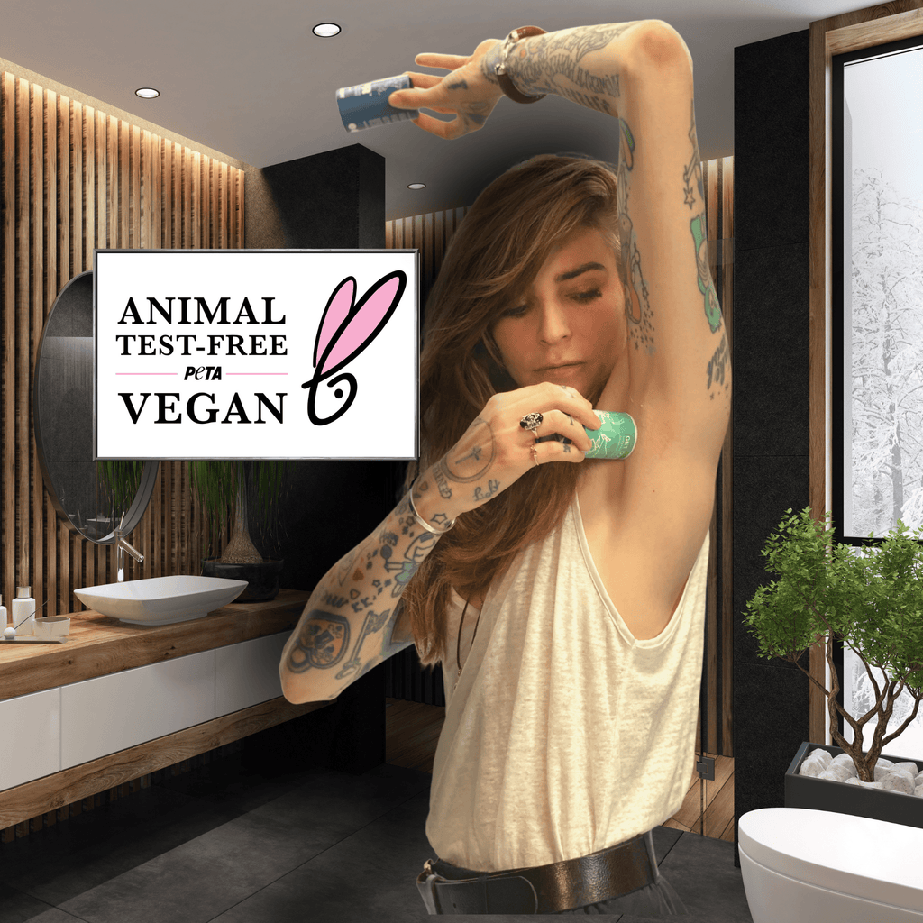 Woman applying deodorant in a bathroom with a PETA Vegan logo displayed.