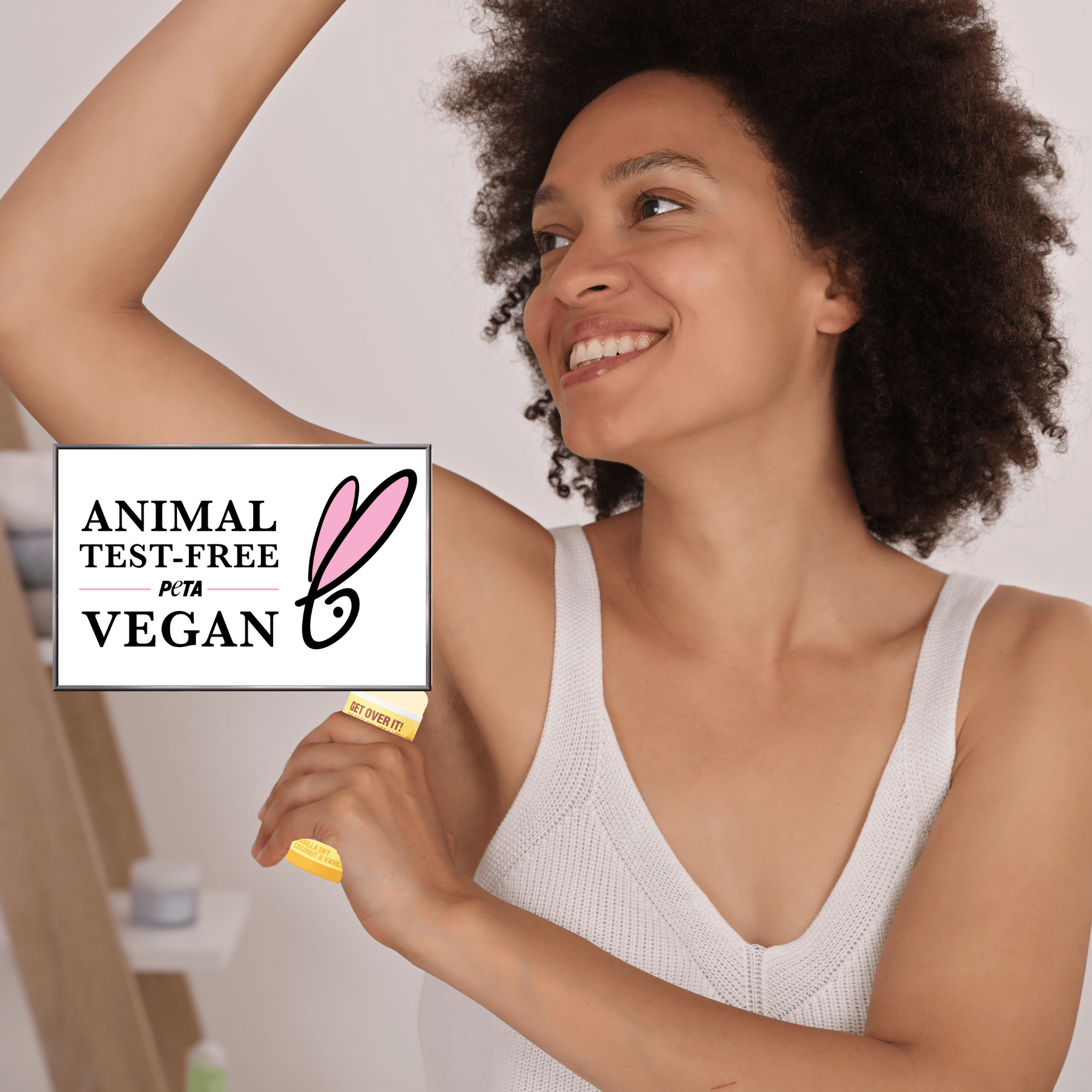 Woman using deodorant product with 'Animal Test-Free' and 'Vegan' label.