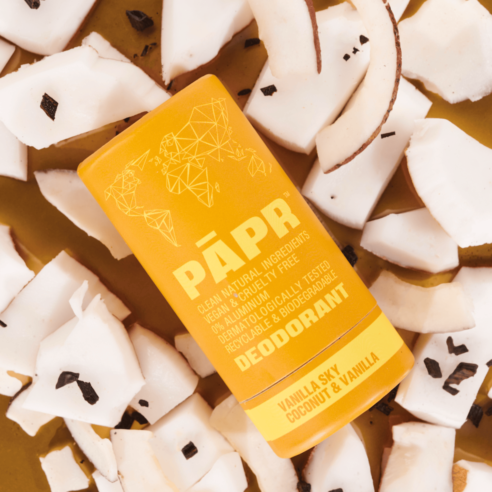 PAPR deodorant bar on a background of coconut pieces