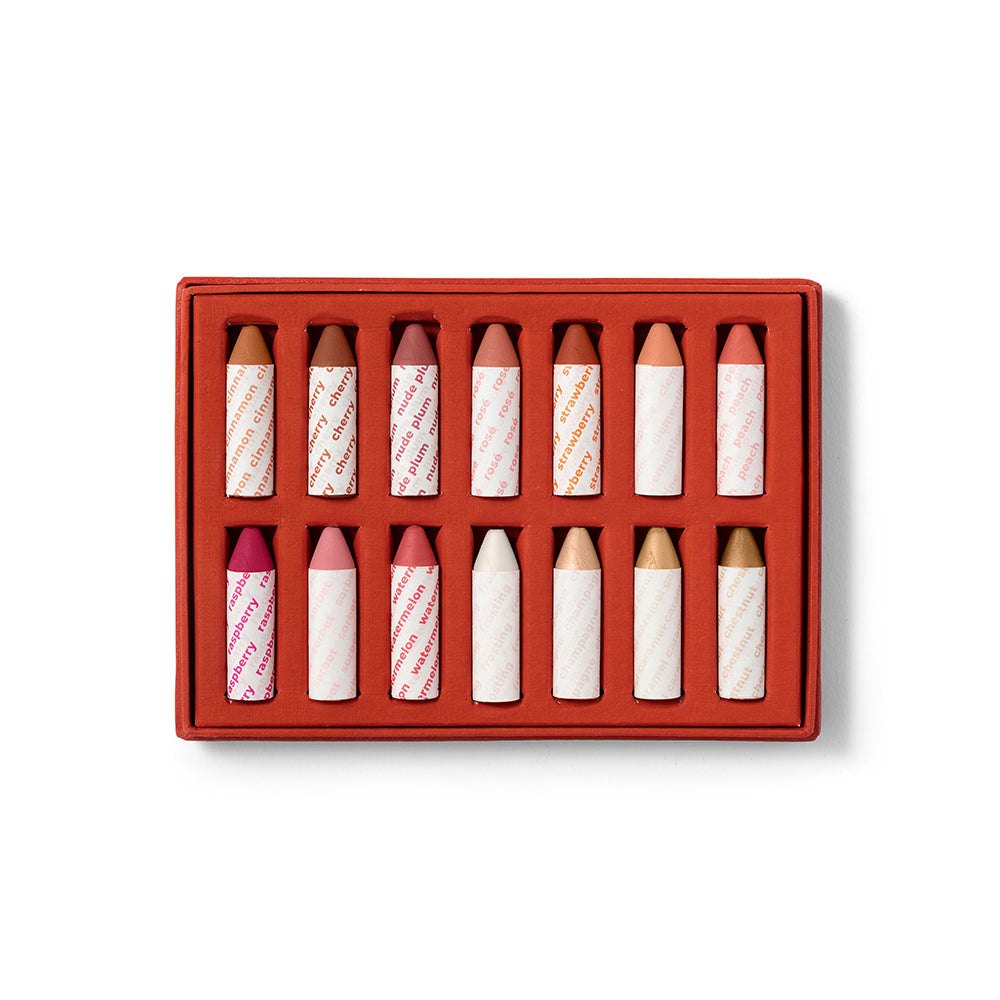 Set of lip crayons in a red box on a white background