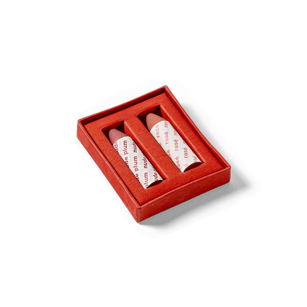 Two lip balms in a red box on a white background