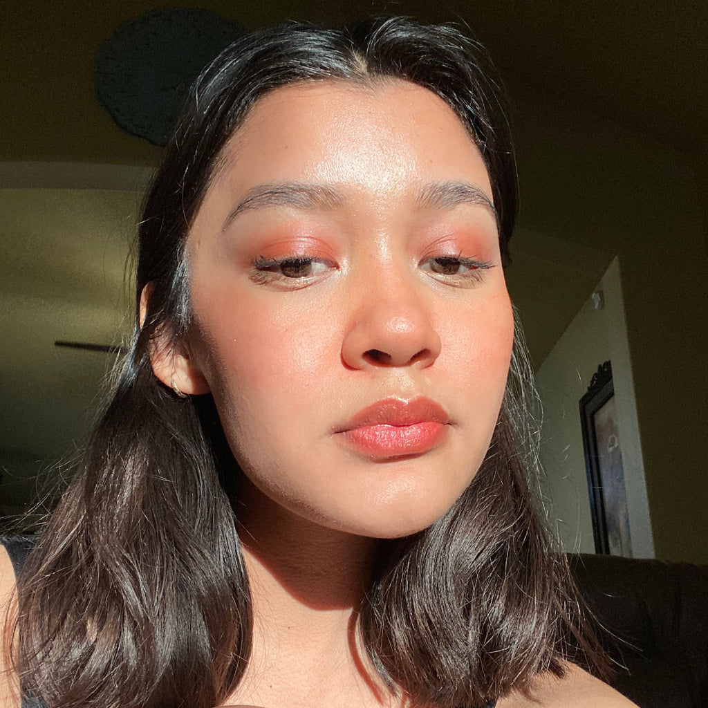 Close-up of a person with makeup looking directly at the camera.