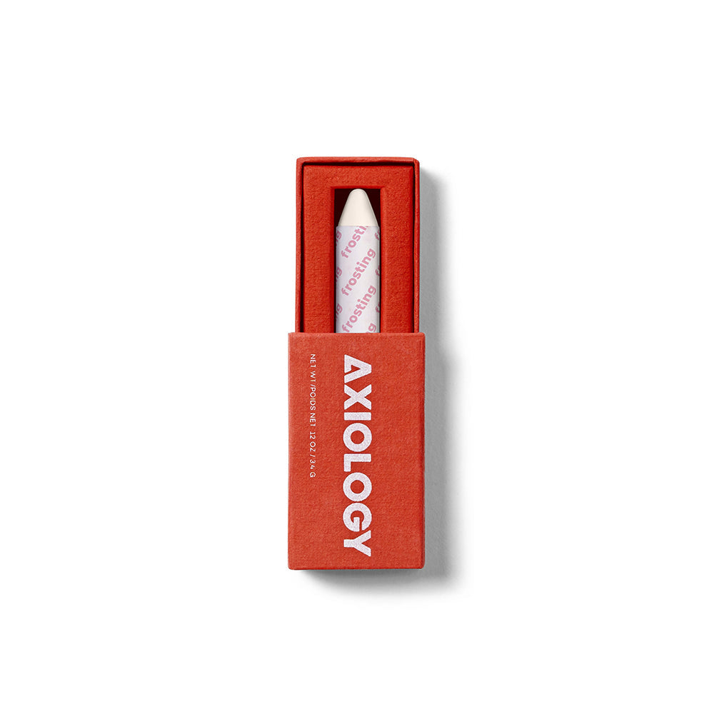 Red Axiology box with a lip crayon on a white background