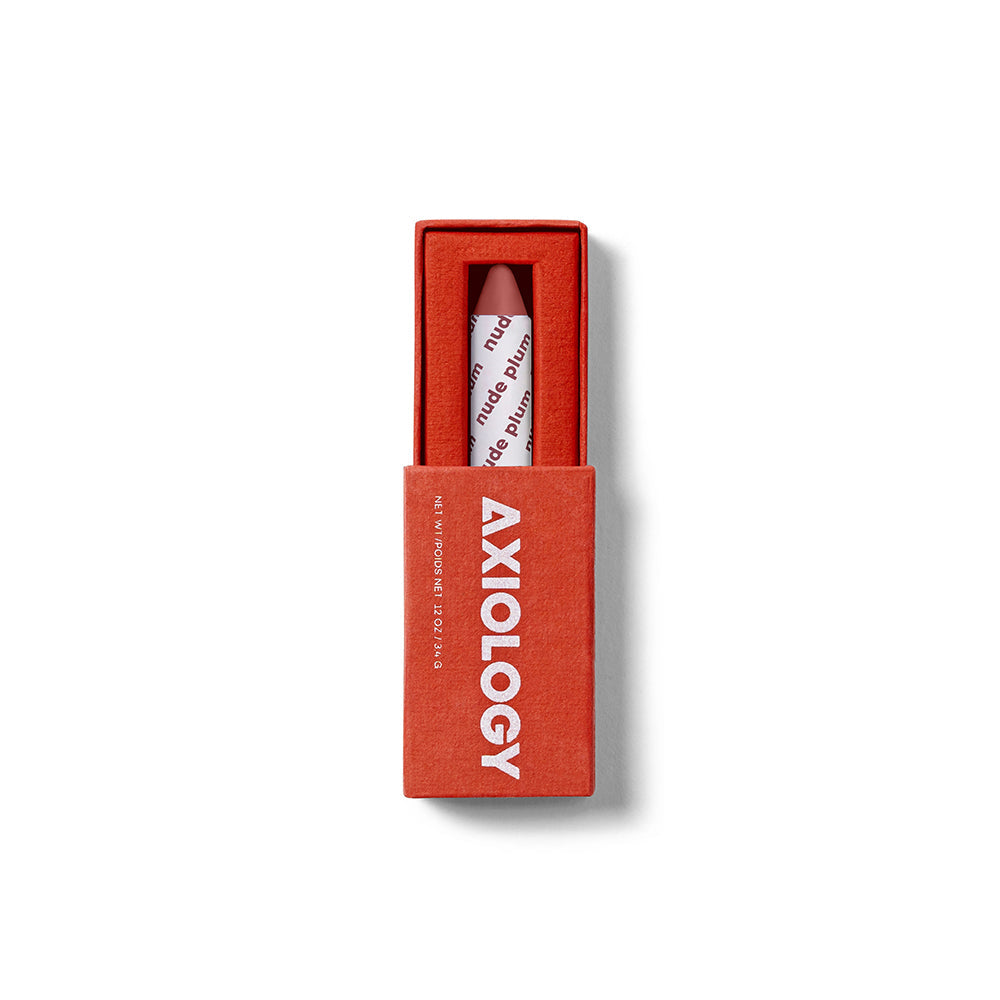 Plum lip crayon in a red box with 'Axiology' branding on a white background