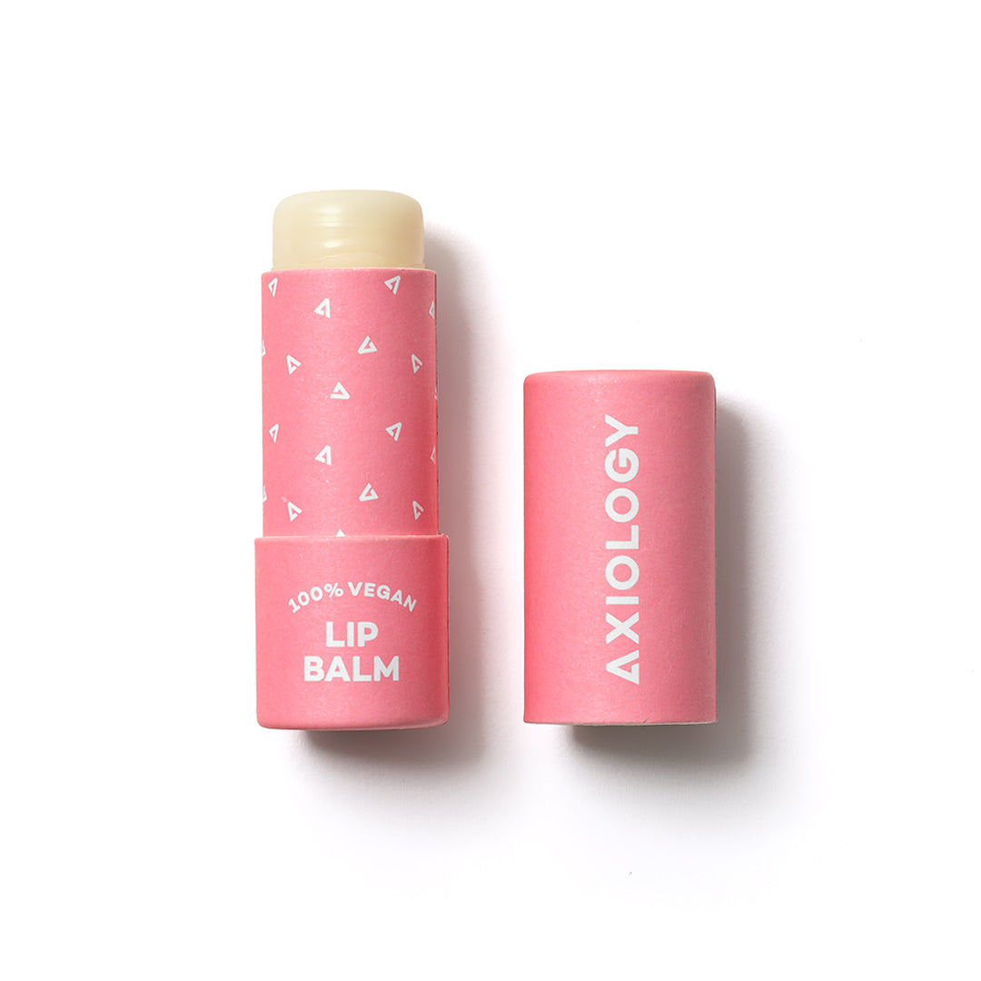 Pink lip balm tube with 'Axiology' branding on a white background