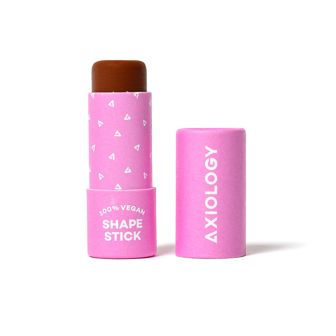 Pink cosmetic stick with top on a white background, featuring 'Axiology' branding.