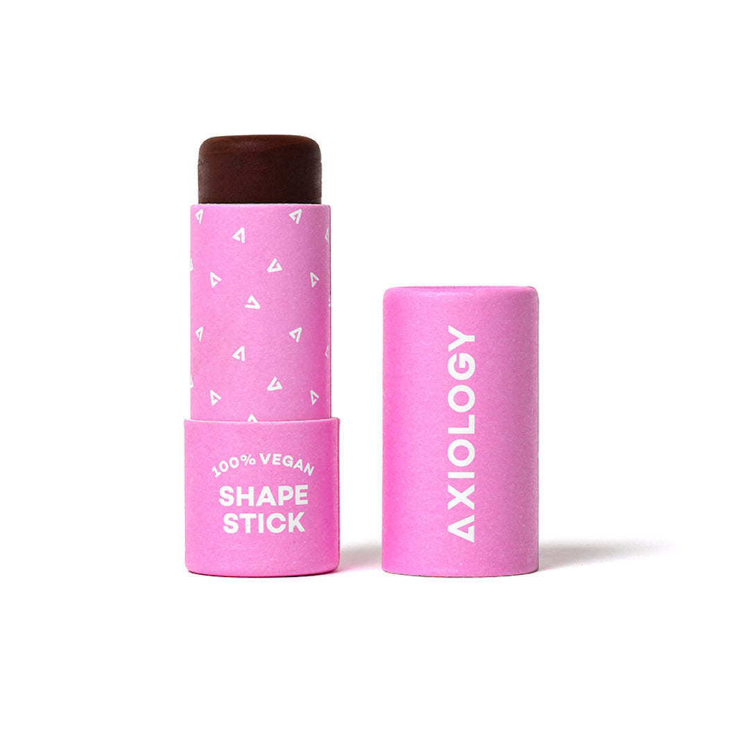 Pink cosmetic stick and cap with 'Axiology' branding on a white background