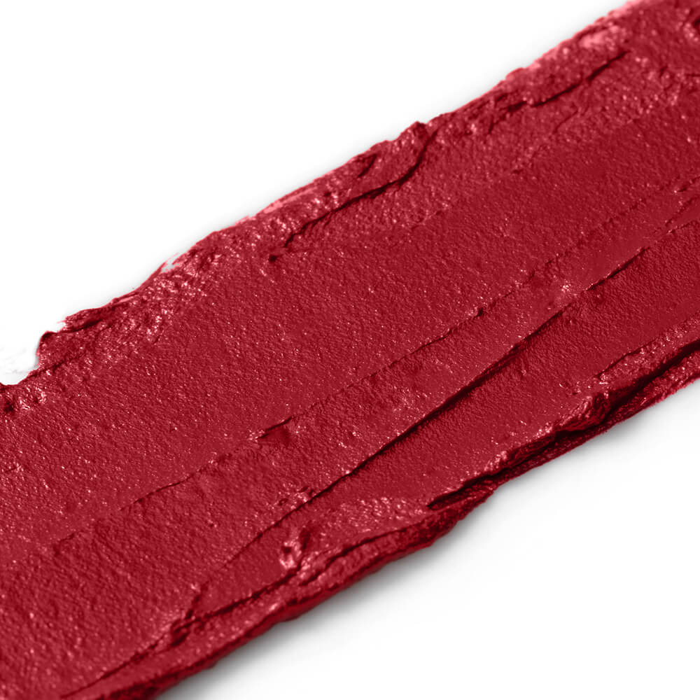 Close-up of a swatch of red lipstick on a white background