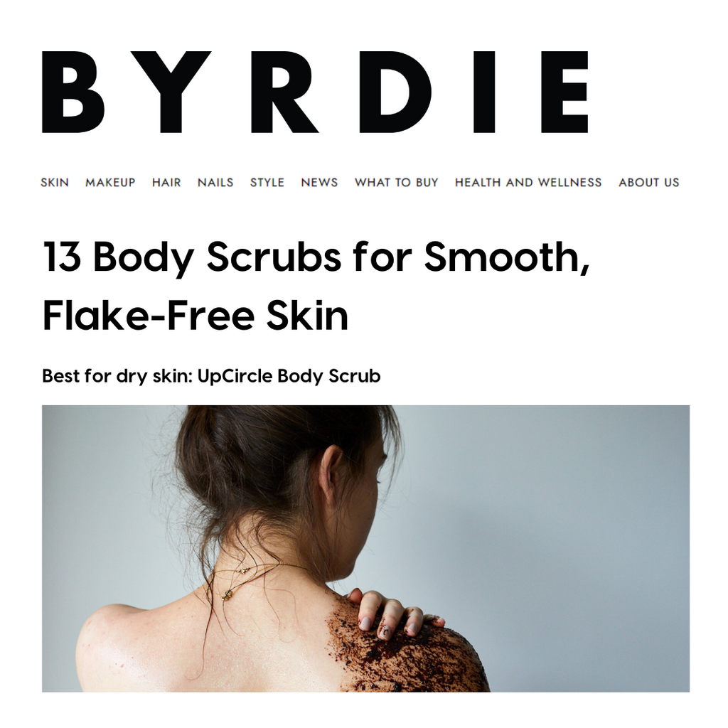 Byrdie article about body scrubs with a woman applying scrub to her back.