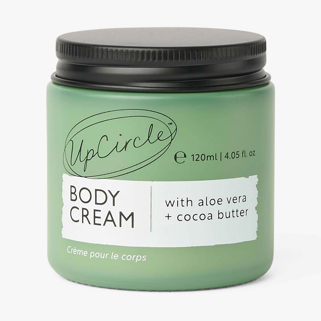 Green jar of UpCircle body cream with a black lid on a white background