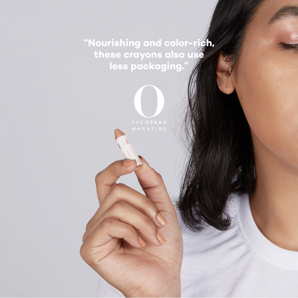 Person holding a crayon with text about crayons being nourishing, color-rich, and having less packaging.