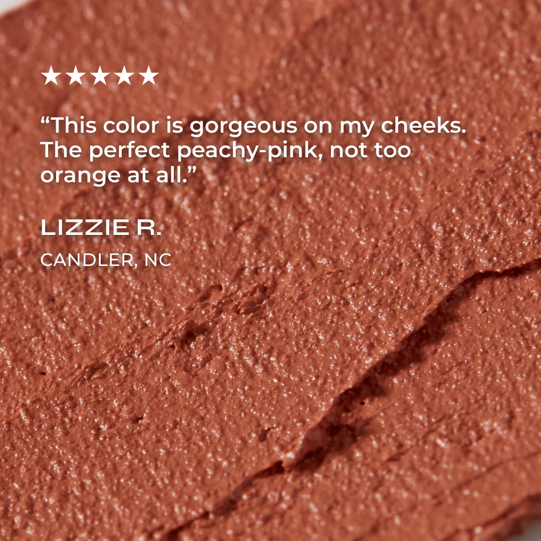 Close-up of a peachy-pink makeup product with a five-star rating and customer review.