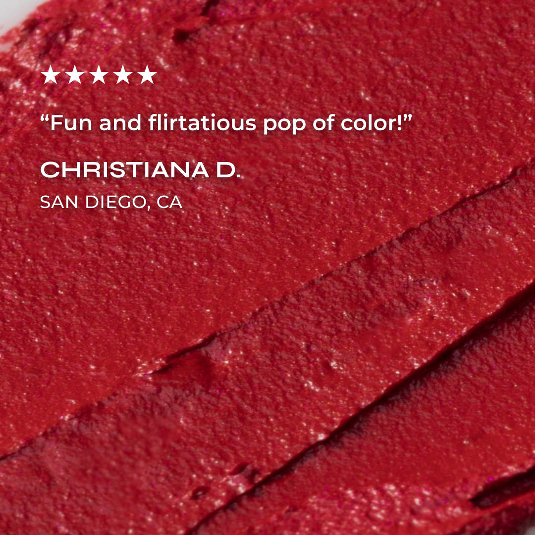 Close-up of red lipstick with a review quote and name on a red background