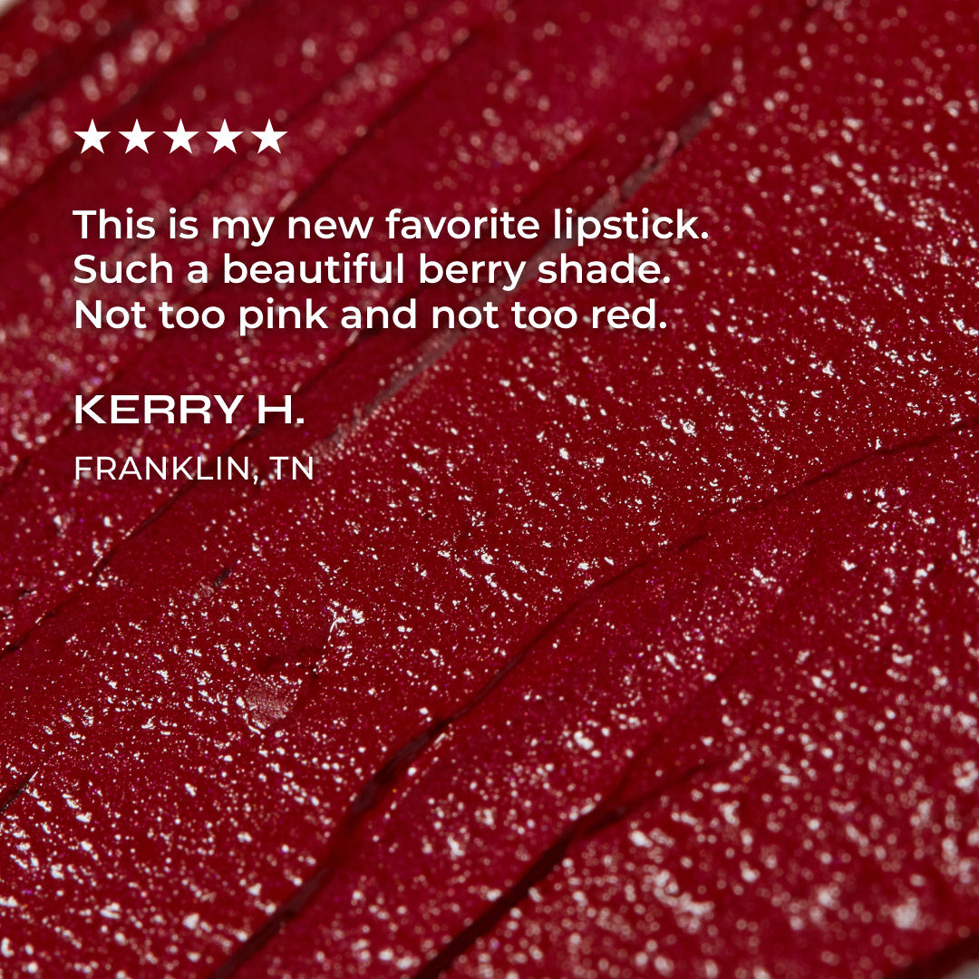 Close-up of a red lipstick with a review text overlay