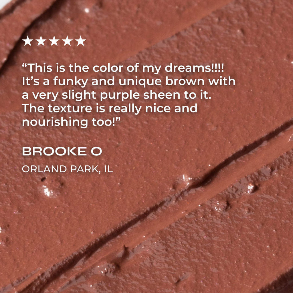 Close-up of brown cosmetic product with text describing its color and texture.