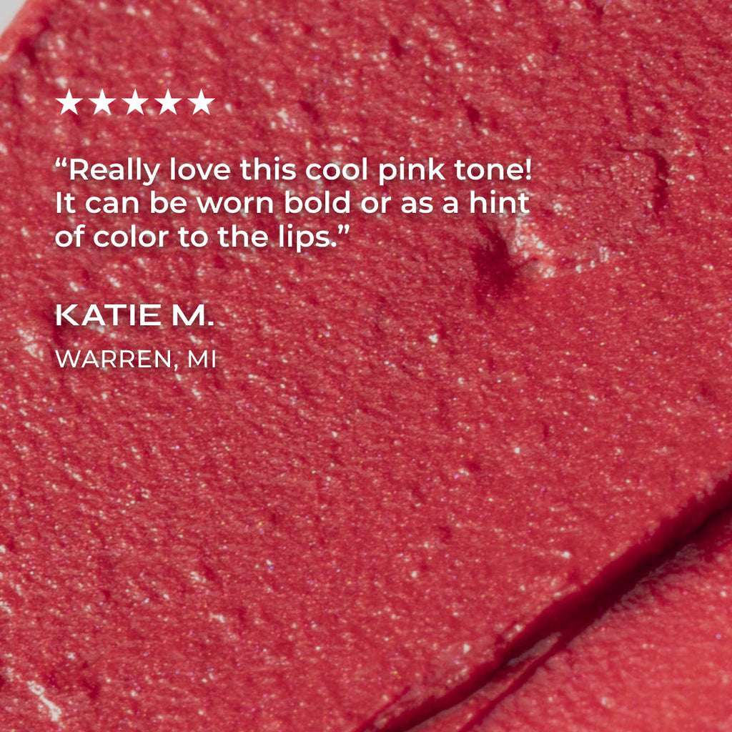 Close-up of a pink makeup swatch with a customer review on a red background