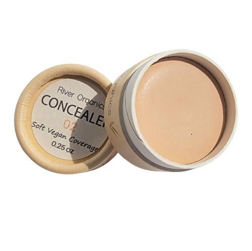 Open container of River Organics concealer on a white background
