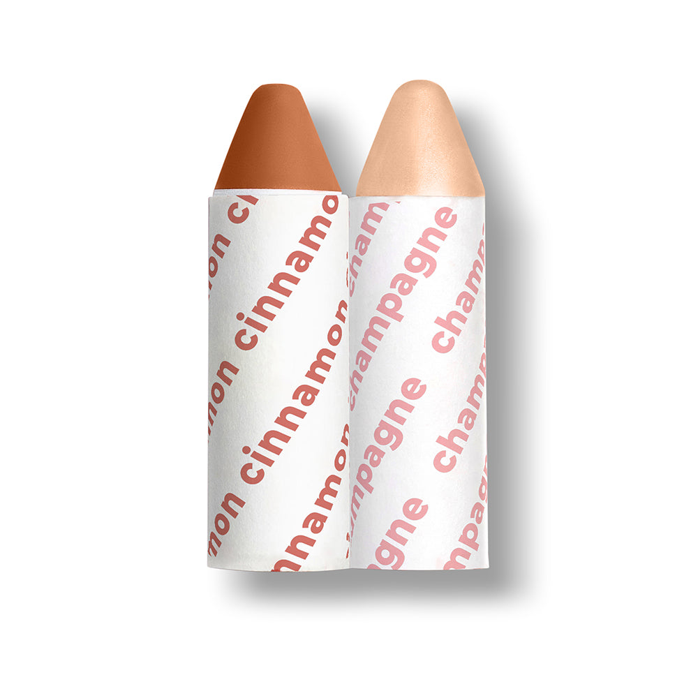 Two makeup crayons with 'cinnamon' and 'champagne' text on white background